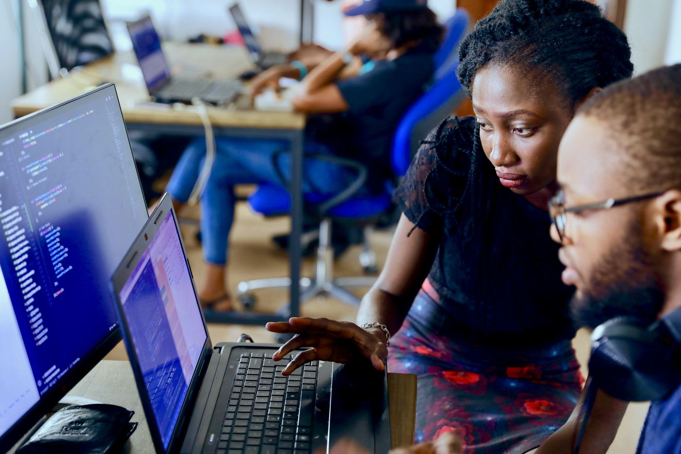 Colleagues working together on a laptop in an office