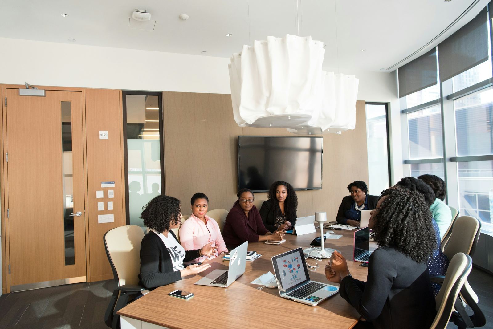 A management team meeting around a boardroom table
